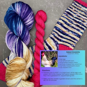 May include: An image featuring colorful yarn skeins and a knitted sock. The yarn is in shades of blue, purple, and gold, and a vibrant pink. The sock has blue, beige, and pink stripes. A recipe card for a baked omelet is also included.