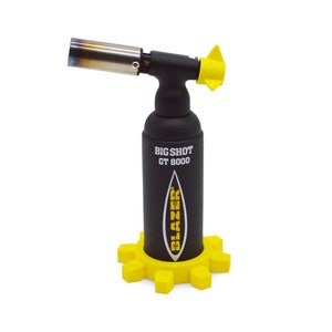 May include: A black torch lighter with a yellow tip and a yellow base. The torch is labelled "BIG SHOT GT 8000" and "BLAZER".
