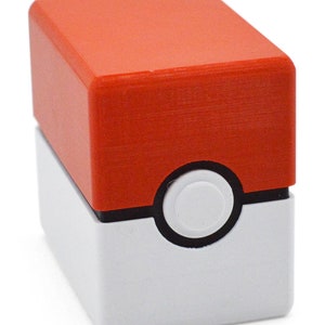 This box contains pokemon cards in a red and white Pokeball style design. This is a storage container for pokemon cards and small valuables.