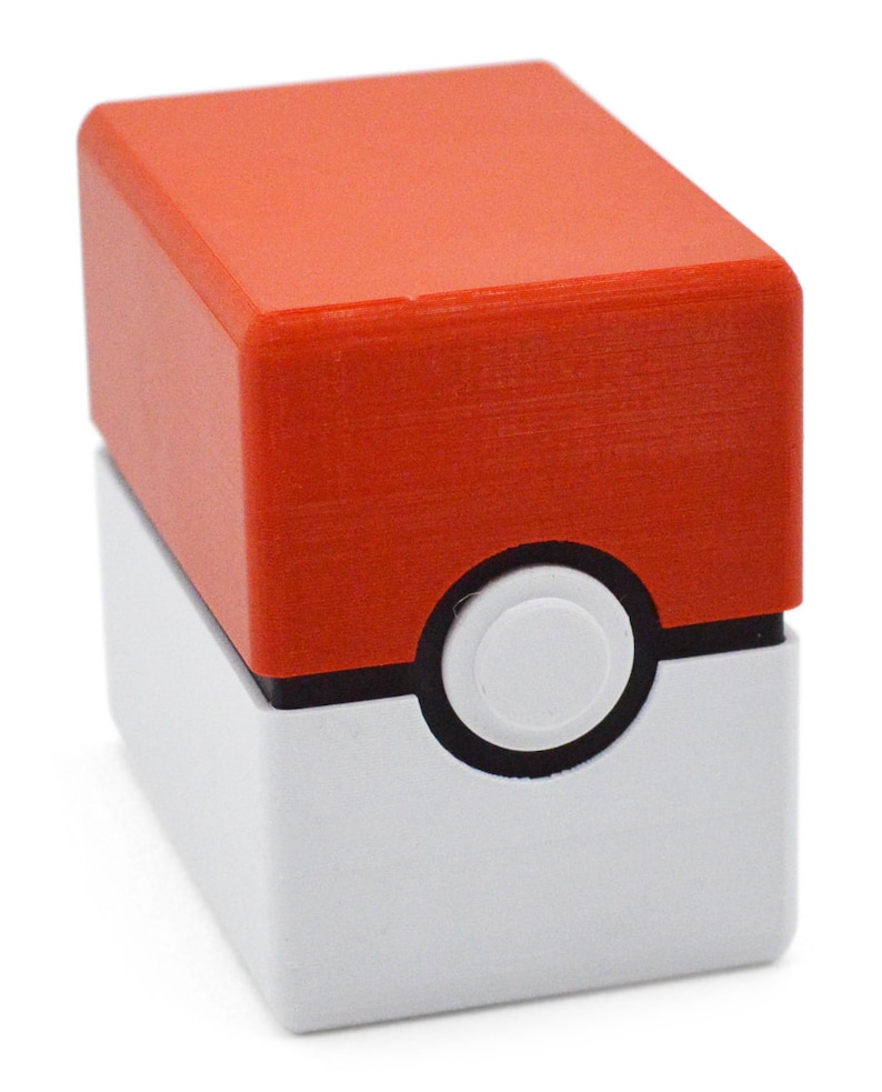 This box contains pokemon cards in a red and white Pokeball style design. This is a storage container for pokemon cards and small valuables.