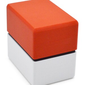 This box contains pokemon cards in a red and white Pokeball style design. This is a storage container for pokemon cards and small valuables.