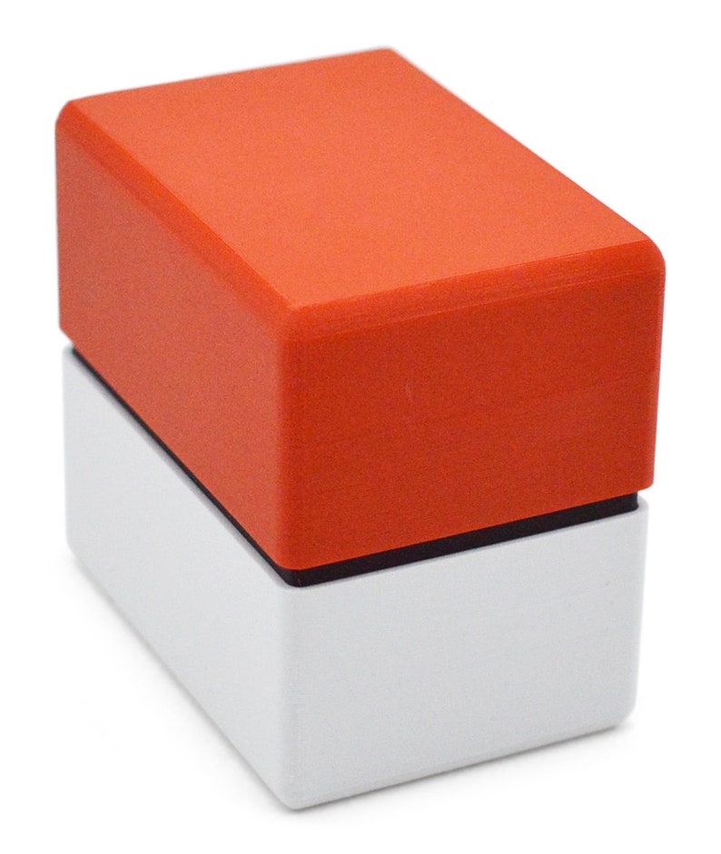 This box contains pokemon cards in a red and white Pokeball style design. This is a storage container for pokemon cards and small valuables.