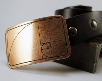 May include: A copper belt buckle with a black leather belt. The buckle features a design of the golden ratio, a mathematical concept that appears in nature.
