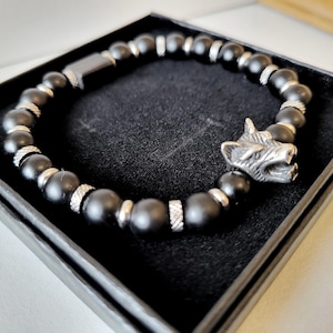 Reversible black wolf men's bracelet in ebony wood, Icelandic obsidian beads, and wolf beads and stainless steel spacers