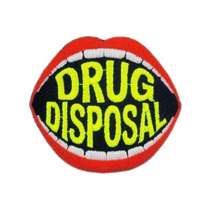 May include: Embroidered patch featuring a stylized mouth with red lips, white teeth, and a black interior. The words "DRUG DISPOSAL" are in bright yellow, outlined in black. The patch is designed to be sewn or ironed onto fabric.