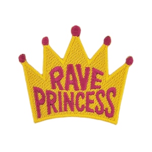 May include: Embroidered patch in the shape of a yellow crown with the words "RAVE PRINCESS" in pink. The crown has five points, each topped with a pink circle. The patch is designed to be ironed on or sewn onto clothing or accessories.