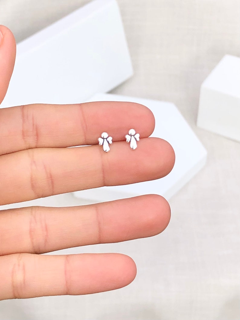 May include: A pair of silver angel wing stud earrings. The earrings are small and delicate, and they would make a great gift for someone special.