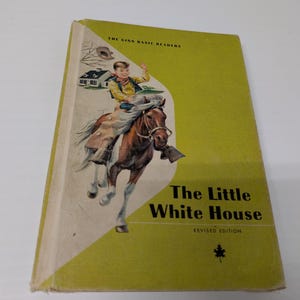 May include: Vintage children's book titled "The Little White House" with a lime green cover. The cover illustration depicts a boy riding a brown horse. The book is part of "The Ginn Basic Readers" series.