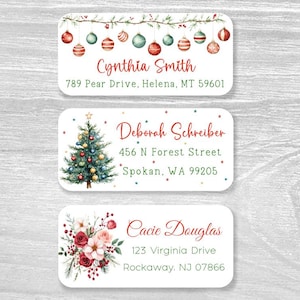 May include: Three rectangular address labels with rounded corners. The top label features hanging Christmas ornaments, the middle shows a decorated Christmas tree, and the bottom displays a floral arrangement with red and white flowers and berries.