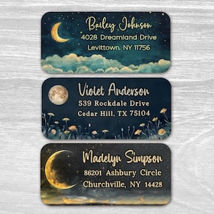May include: Three rectangular address labels featuring celestial themes. The top label shows a crescent moon and clouds. The middle label displays a full moon and wildflowers. The bottom label depicts a large moon and stars. Each label includes names and addresses.
