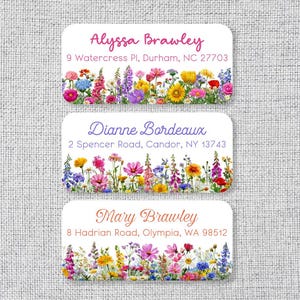 May include: Three rectangular address labels with rounded corners, each featuring a unique name and address printed above a colorful illustration of various wildflowers in shades of pink, yellow, blue, purple, and white on a white background.