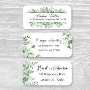 May include: Three rectangular address labels with rounded corners, featuring white backgrounds and green watercolor leaf illustrations. The labels display names and addresses including Amelina Bedison, Morgan Hansley, and Baroline Robinson.