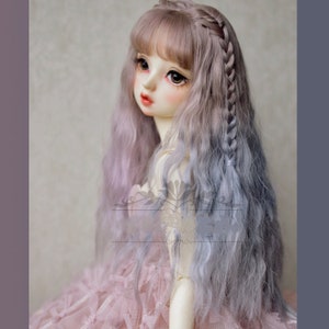 May include: A doll with long, wavy, two-toned hair. The hair is light pink at the top and fades to a light blue at the ends. The doll has a side braid and bangs.