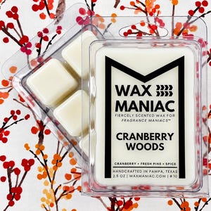 May include: Two clear plastic clamshell containers filled with off-white wax melts. The label reads WAX MANIAC, FIERCELY SCENTED WAX FOR FRAGRANCE MANIACS, CRANBERRY WOODS, CRANBERRY, FRESH PINE, SPICE, HANDCRAFTED IN PAMPA, TEXAS, 2.5 OZ, WAXMANIAC.COM | # 10.