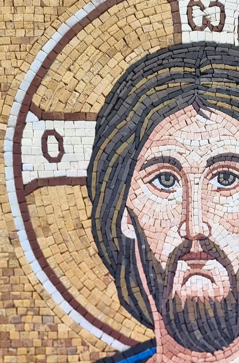 May include: A mosaic artwork depicting a religious figure with a halo. The portrait features a detailed face with a beard, dark hair, and light skin tones. The mosaic is composed of small, square tiles in various colors.