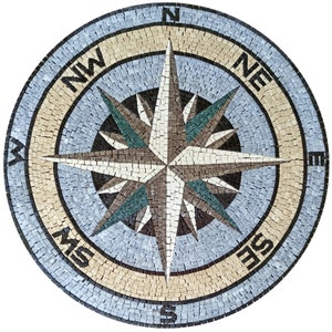 May include: A circular mosaic compass rose with a blue background and a beige outer ring. The compass rose is made of small, square tiles in various shades of brown, beige, and blue. The compass points are labeled with the letters N, S, E, W, NE, NW, SE, and SW.