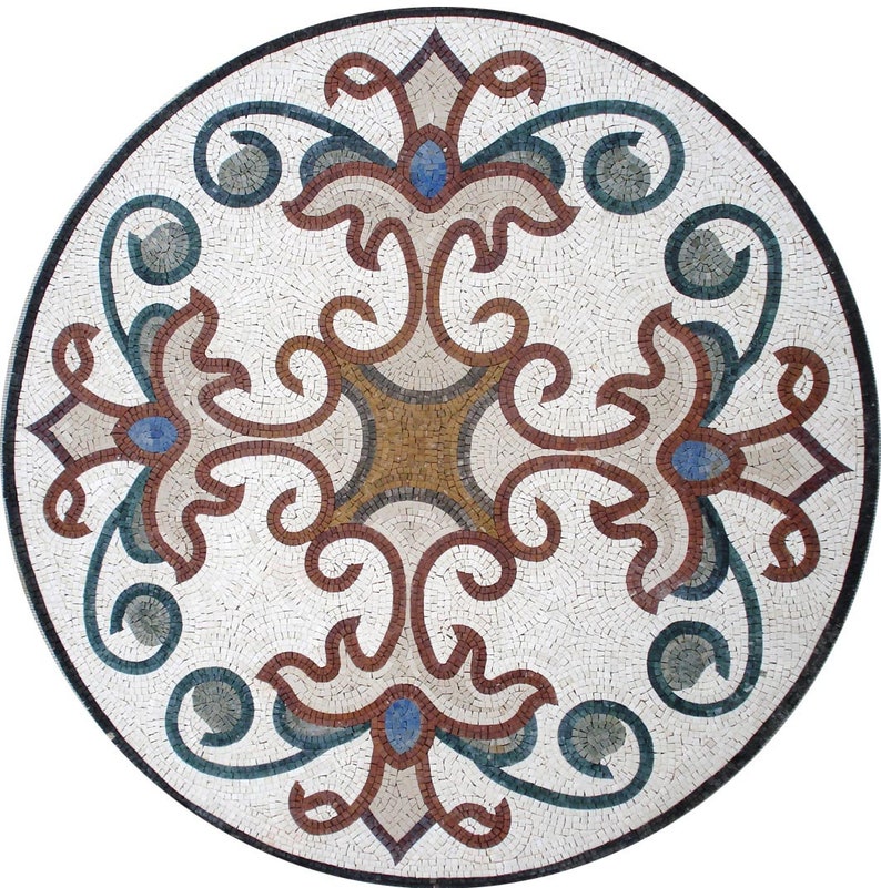 May include: A round mosaic tile with a white background and a brown, blue, and green floral design. The design is symmetrical and features intricate details.