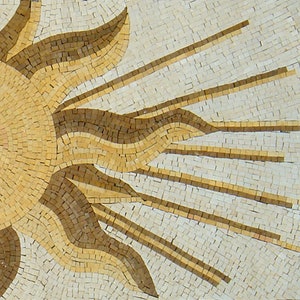 May include: A mosaic tile design of a sun with rays emanating from the center. The sun is made of small, square tiles in shades of beige and brown.