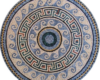 May include: A round mosaic tile with a blue and white geometric pattern. The center of the tile features a smaller circle with a blue, green, and white design. The tile is surrounded by a border of blue and white waves.