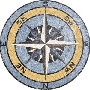 May include: A round mosaic compass with a white, black, and blue star design. The compass points are labeled N, S, E, W, NE, NW, SE, and SW. The compass is surrounded by a yellow and blue ring.