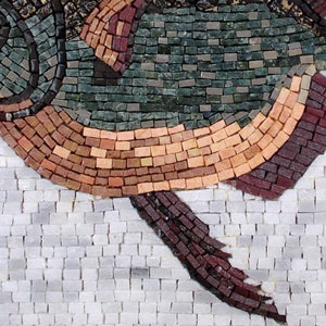 May include: Close-up of a mosaic artwork depicting a fish. The fish is composed of small, rectangular tiles in shades of green, brown, and red. The background is white, creating a striking contrast. The mosaic style gives the artwork a textured appearance.