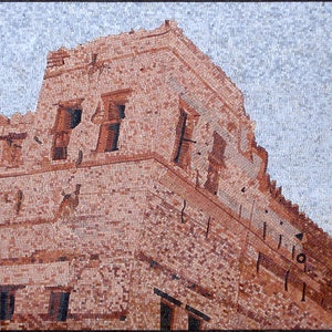 May include: A mosaic artwork depicting a red brick building with multiple windows. The building has a unique architectural style with a corner that juts out. The sky is a light blue color.