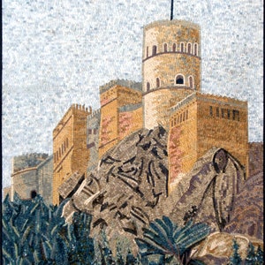 May include: A mosaic artwork depicting a castle with a tower and a flag on top. The castle is built on a rocky hill with palm trees in the foreground. The artwork is made of small, colorful tiles.