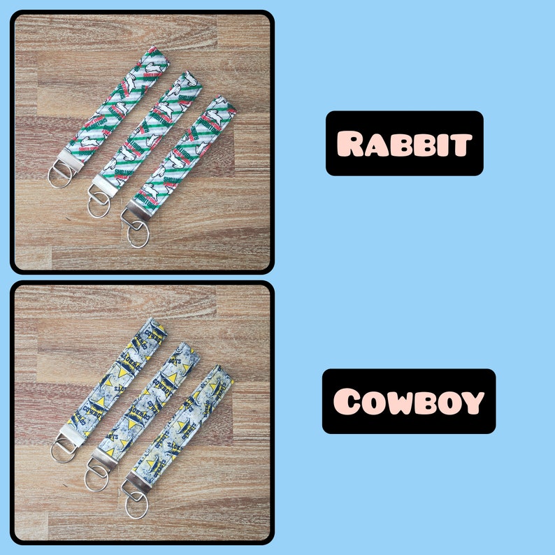May include: Three keychains with different designs. The first keychain has a green and white pattern with the word "RABBIT" printed on it. The second keychain has a blue and white pattern with the word "COWBOY" printed on it. The keychains are on a wooden surface.