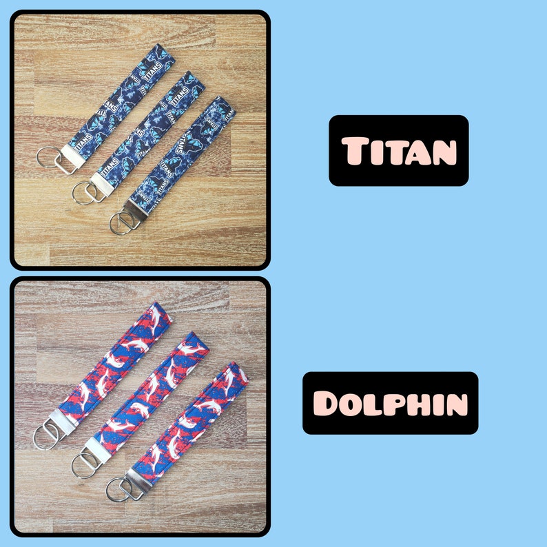 May include: Two sets of keychains, one with a blue and white pattern and the word "TITAN" printed on it, and the other with a red and white pattern and the word "DOLPHIN" printed on it.