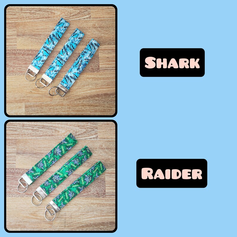 May include: Three blue keychains with a shark print design and three green keychains with a raider print design. The keychains are on a wooden surface.