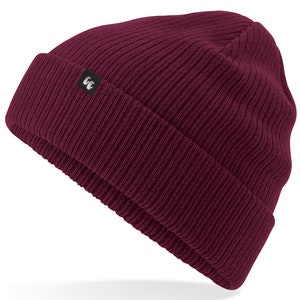 Burgundy organic cotton beanie hat with black fabric tag stitched to the cuff