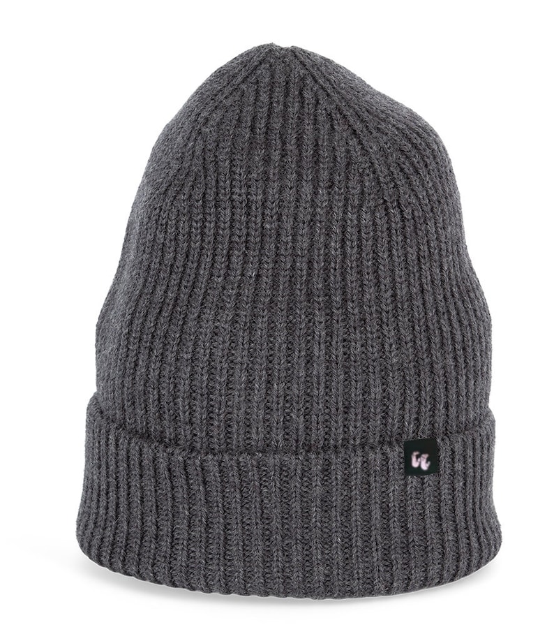 A dark heather grey beanie with chunky, fisherman-style ribbed knit. It has a black fabric label with a white logo stitched to the cuff