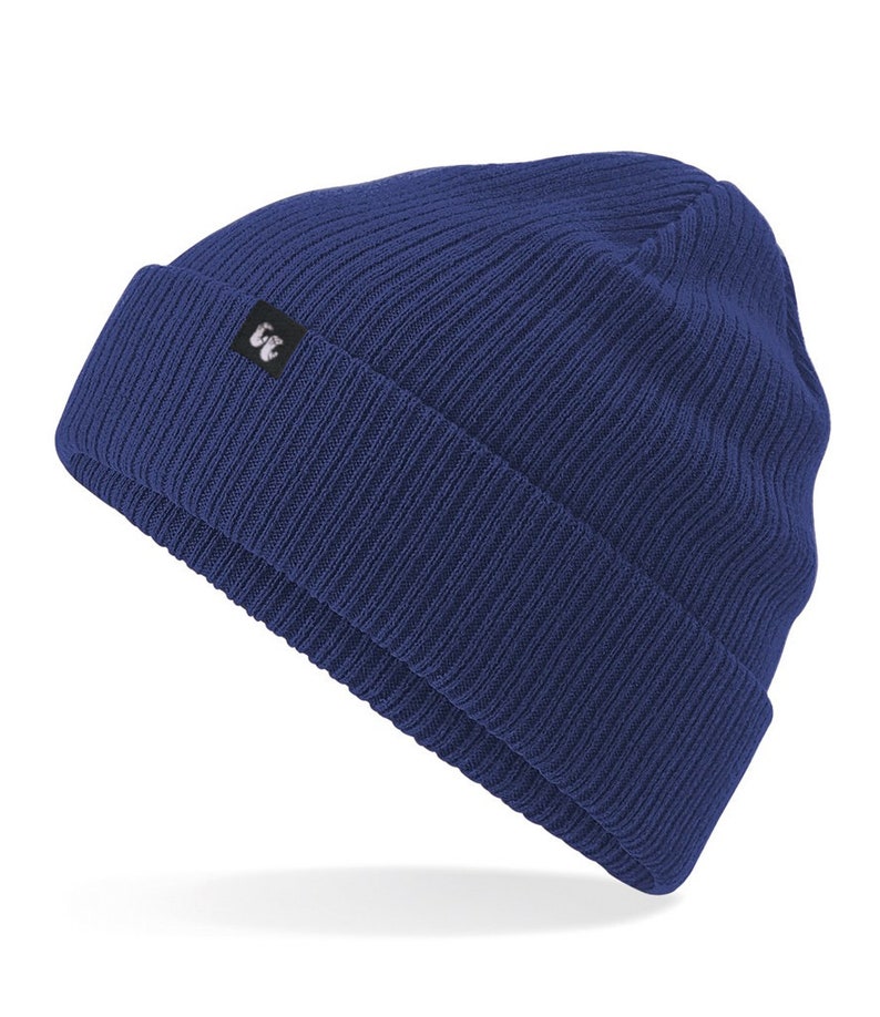 Navy blue organic cotton beanie hat with black fabric tag stitched to the cuff