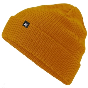 Mustard yellow organic cotton beanie hat with black fabric tag stitched to the cuff