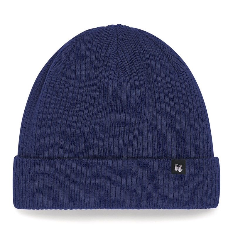 Front view of navy blue organic cotton beanie hat with black fabric tag stitched to the cuff