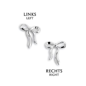 May include: Two silver-colored bow-shaped earrings. The earrings have a detailed design with a bow knot and flowing ribbon ends. The text "LINKS LEFT" and "RECHTS RIGHT" are above and below the earrings.