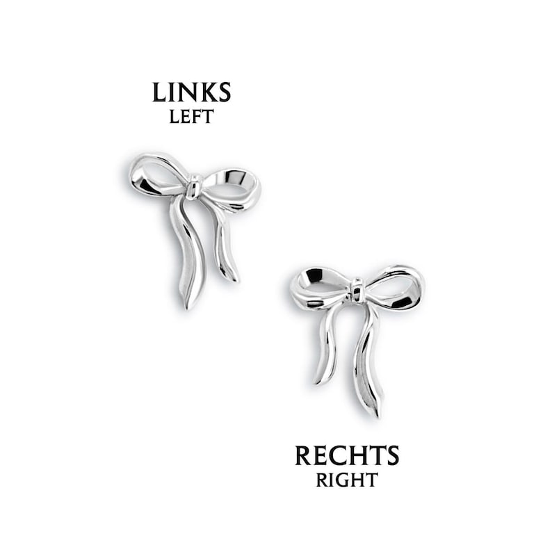 May include: Two silver-colored bow-shaped earrings. The earrings have a detailed design with a bow knot and flowing ribbon ends. The text "LINKS LEFT" and "RECHTS RIGHT" are above and below the earrings.