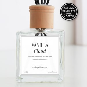 May include: A clear glass aromatherapy diffuser with black reeds and a light brown cap. The label reads "Vanilla Cloud" with scent notes. The diffuser is 6 oz (177 ml) and includes a "Canva" template sticker.