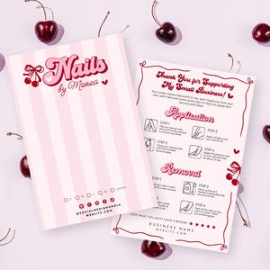 May include: Two pink and white striped cards with the text "Nails by Monica" and instructions for nail application and removal, surrounded by fresh cherries. The cards feature a retro font and cherry illustrations.