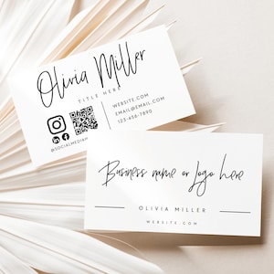 May include: Two white business cards with black text. One card reads "Olivia Miller" with contact information and social media icons. The other card says "Business name or logo here" and "Olivia Miller". The cards are on a white leaf.