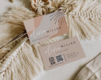 May include: Two rectangular business cards featuring a soft peach and cream abstract design. The top card displays the name Olivia Miller and a sunburst graphic. The bottom card includes the name, title, QR code, and contact details.