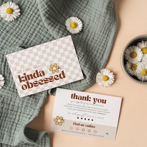 May include: Two rectangular cards with a beige and white checkerboard pattern and brown text. One card reads "GET READY TO BE kinda obsessed" with a flower icon. The other card says "thank you" and includes social media icons and five stars.