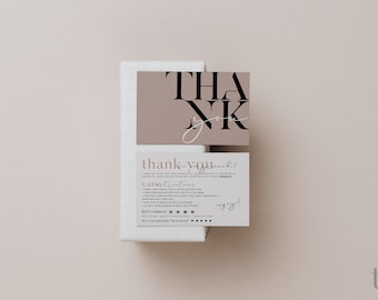 May include: A rectangular white box topped with two stacked cards. The top card is taupe with the black text THANK YOU. The bottom card is light gray with black text providing candle care instructions and social media contact information.