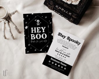 May include: Two rectangular cards with black and white designs. One card features a skull icon, stars, and the text HEY BOO thanks for your order. The other card displays Stay Spooky, a discount code, review request, and social media icons.