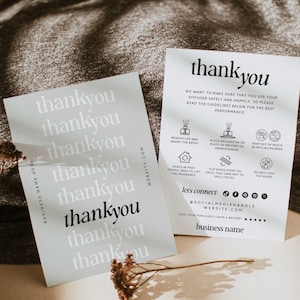 May include: Two rectangular white cards with black text. The left card features the word thank you repeated in varying shades of gray and black. The right card provides diffuser safety guidelines with icons and text, including social media icons.