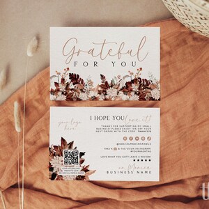 May include: Two rectangular white business cards with floral autumn-themed graphics. The top card reads Grateful For You. The bottom card includes text I Hope You Love It, a QR code, social media icons, and placeholders for a logo and business name.