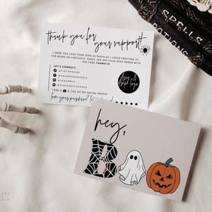 May include: Two rectangular cards with white and light gray backgrounds. The top card features black text including 'Thank you for your support' and social media icons. The bottom card displays the text 'hey, BOO' with a spiderweb letter B, a white ghost, and an orange pumpkin.