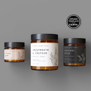 Può includere: Tre barattoli di vetro con coperchi neri ed etichette. Le etichette recitano "citrus glow", "rejuvenate & restore" e "charcoal detox". Ogni etichetta ha un design botanico minimalista. I barattoli sono su sfondo grigio.