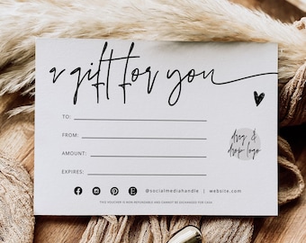 May include: A white rectangular gift voucher with black text reading A gift for you, with lines for To, From, Amount, and Expires. It includes social media icons, a website placeholder, and a small heart graphic, alongside a gold wax seal stamp.