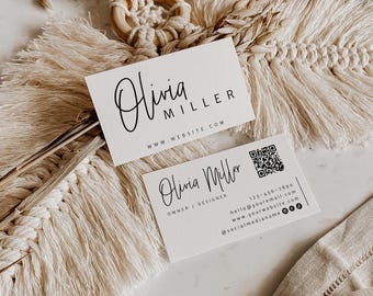 May include: Two white rectangular business cards with black text. The top card displays the name Olivia Miller and a website URL. The bottom card features the name Olivia Miller, title Owner/Designer, a QR code, phone number, email, and social media icons.